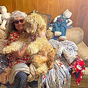 Gunner is registered to the contest to win money with this photo: art, child, companion_dog, costume, entertainment, event, fashion_design, fictional_character, flesh, fun, fur, hat, performing_arts, room, sitting, stuffed_toy, sunglasses, teddy_bear, toy, tradition