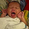 baby, yawning, blanket, infant, sleepy, hands, face, mouth_open, cozy, colorful_blanket, newborn, wrapped, cute, indoor, portrait, skin, head, small_hands, resting, soft