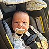 baby, infant, pacifier, car_seat, straps, blanket, onesie, dinosaur_pattern, expression, face, hand, indoor, child, seatbelt, safety, young_child, cute, portrait, clothing, person
