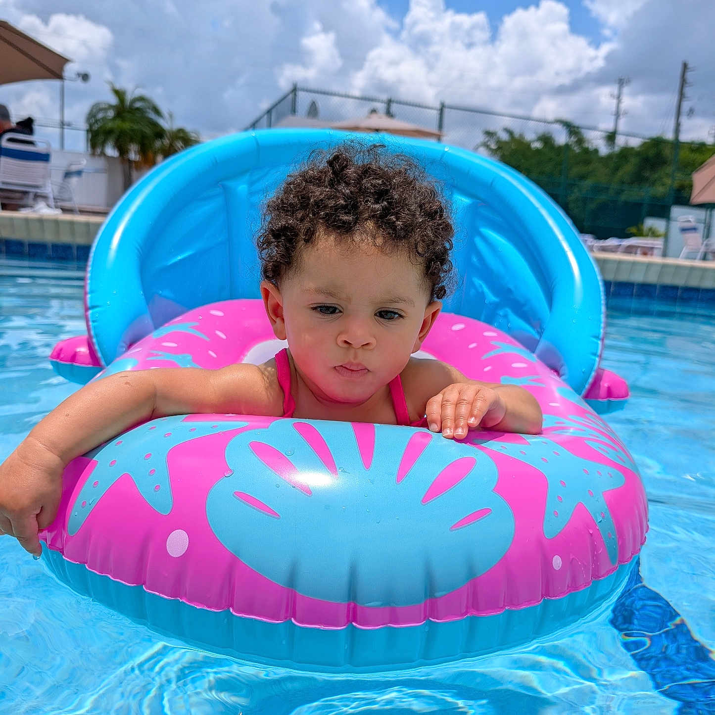 Luisa joined the competition — help win amazing prizes! blue_sky, child, clouds, curly_hair, daytime, float, fun, inflatable, leisure, outdoor, pool, relaxation, summer, sunny, swimming_pool, swimwear, toddler, vacation, water, water_sports