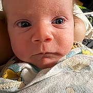 Seth joined the competition — help win amazing prizes! baby, infant, newborn, face, eyes, nose, mouth, closeup, portrait, swaddle, blanket, skin, cheeks, expression, gaze, eyelashes, head, hair, bedding, home