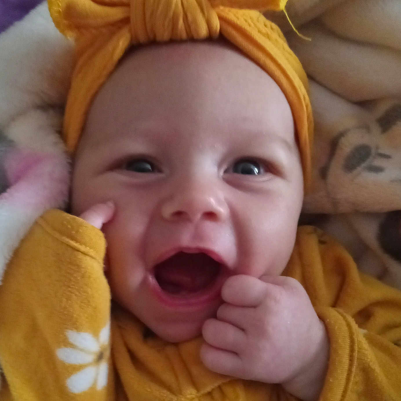 Genesis is registered to the contest to win money with this photo: baby, babylaughing, bodypart, bonnet, clothing, face, finger, hand, happy, hat, head, laughing, mouth, newborn, person, photography, portrait, smile, towel, turban
