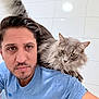 animal, beard, blue_shirt, casual, cat, closeup, companion, feline, fluffy, friendship, gray_cat, human, indoor, looking_away, man, pet, portrait, short_hair, shoulder, white_tiles