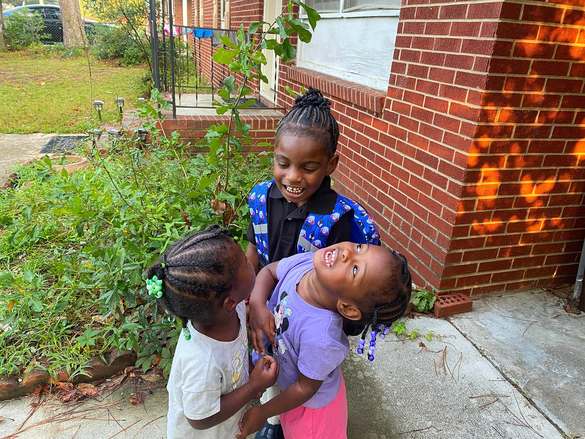 Genesis is registered to the contest to win money with this photo: brick, brickwork, child, event, fun, grass, happy, house, joy, leaf, leisure, neighbourhood, person, plant, shirt, shorts, sitting, smile, soil, summer