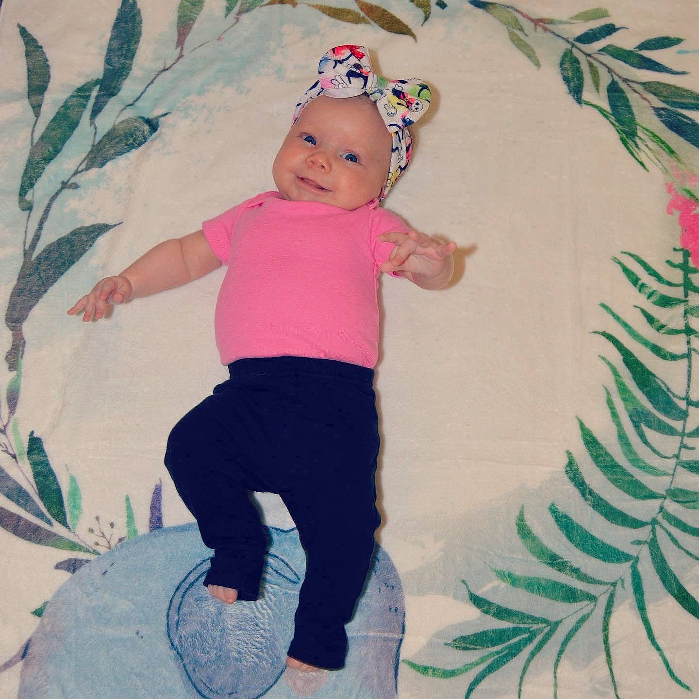 Gracie joined the competition — help win amazing prizes! baby, baby_products, baby_toddler_clothing, child, hair_accessory, headwear, pattern, person, pink, plant, product, smile, textile, toddler