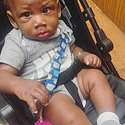 Journii joined the competition — help win amazing prizes! toddler, child, baby, stroller, pacifier, bow, white_bow, socks, gray_shirt, indoor, wooden_paneling, floor, seatbelt, curious, expression, hand, legs, casual_clothing, infant, person