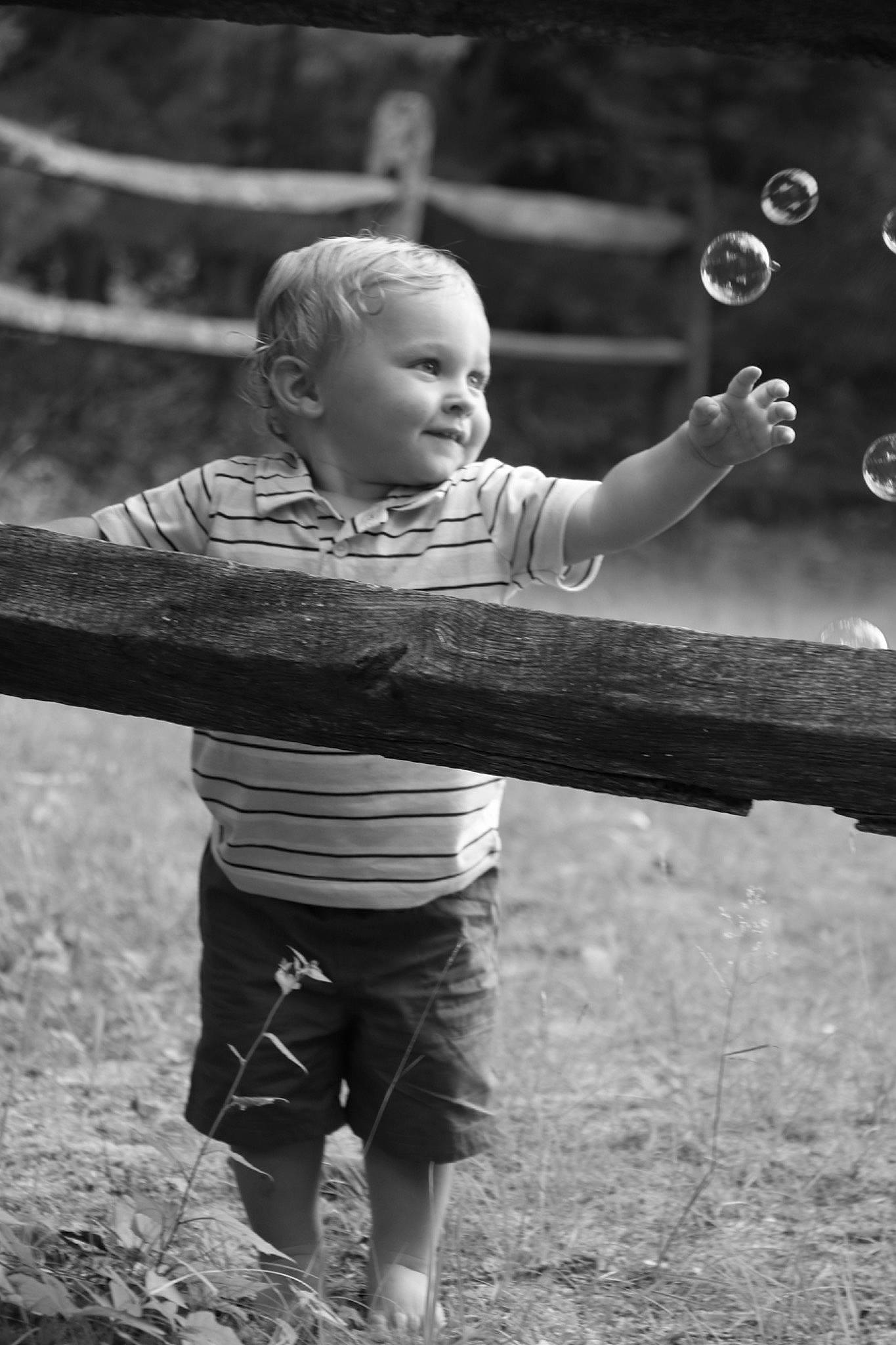 Drew joined the competition — help win amazing prizes! arm, black_and_white, child, facial_expression, flash_photography, fun, gesture, grass, hand, happy, human, monochrome_photography, people_in_nature, person, shorts, smile, standing, style, t_shirt, toddler