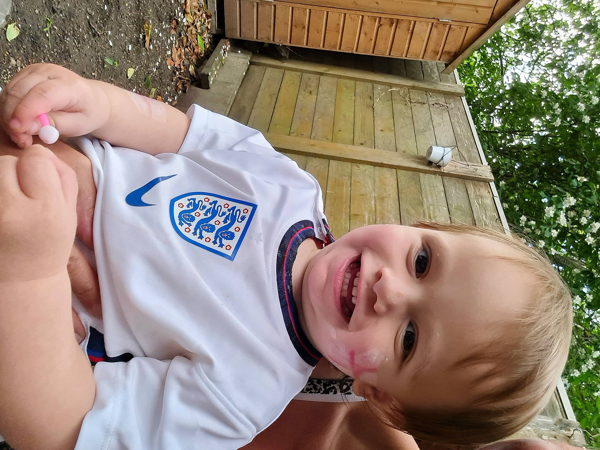 Dustin is registered to the contest to win money with this photo: child, fun, gesture, grass, hand, happy, hat, joy, leisure, mouth, people, people_in_nature, person, play, player, recreation, smile, sportswear, t_shirt, toddler