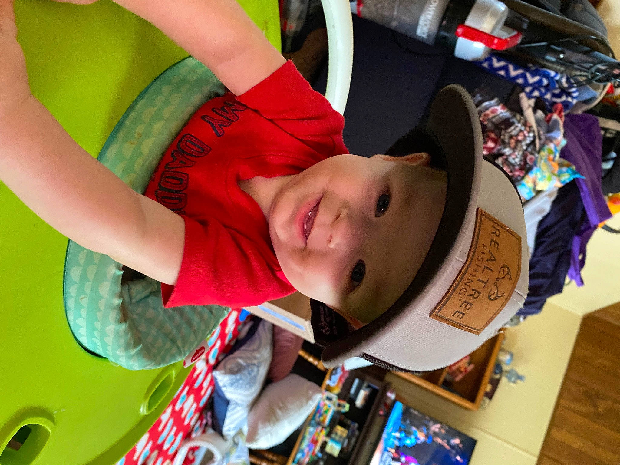 Hunter is registered to the contest to win money with this photo: baby, cap, carmine, child, fashion_accessory, fun, happy, hat, headgear, headwear, leisure, person, recreation, room, smile, t_shirt, toddler