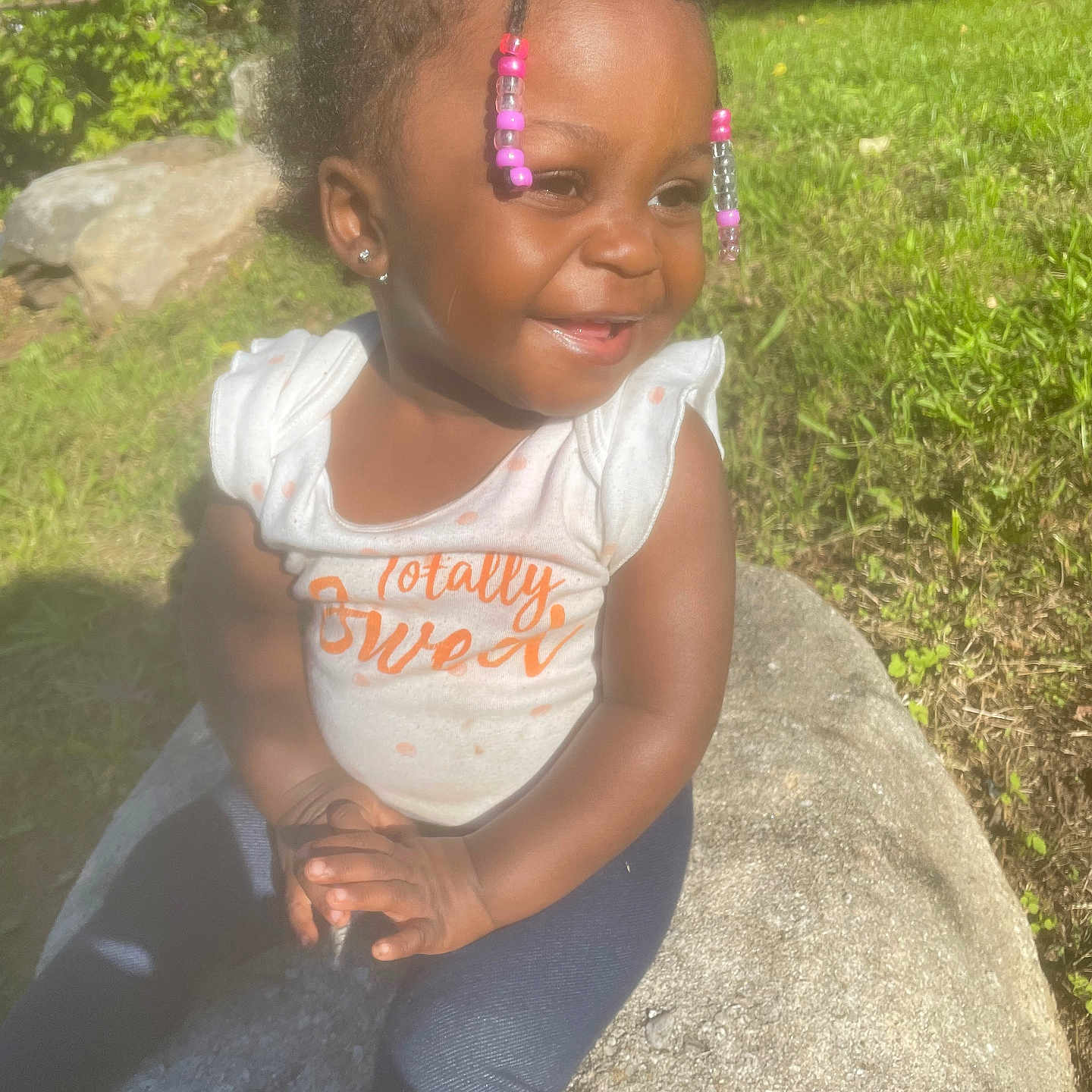 Kalea joined the competition — help win amazing prizes! backyard, child, clothing, face, female, girl, grass, head, nature, outdoors, pants, park, person, photography, plant, portrait, rock, sitting, t_shirt, tree