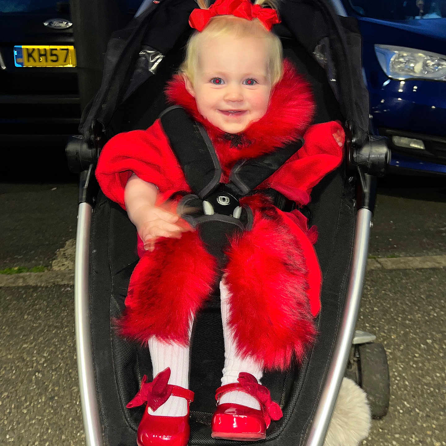 Maya-Lilly is registered to the contest to win money with this photo: asphalt, baby, car, child, cute, evening, fashion, fur_trim, happy, outdoor, parking_lot, person, pigtails, portrait, red_clothing, red_shoes, seatbelt, smiling, stroller, toddler