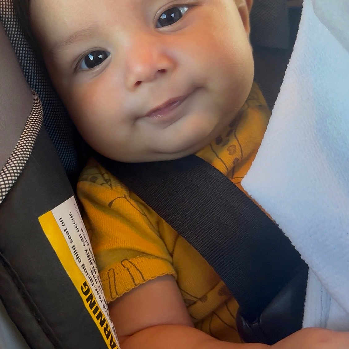 Dariel joined the competition — help win amazing prizes! baby, infant, child, car_seat, buckled_in, portrait, face, wide_eyes, smiling, chubby, yellow_clothing, blanket, vehicle, travel, seated, close_up, indoor, photography, soft_lighting,  안전