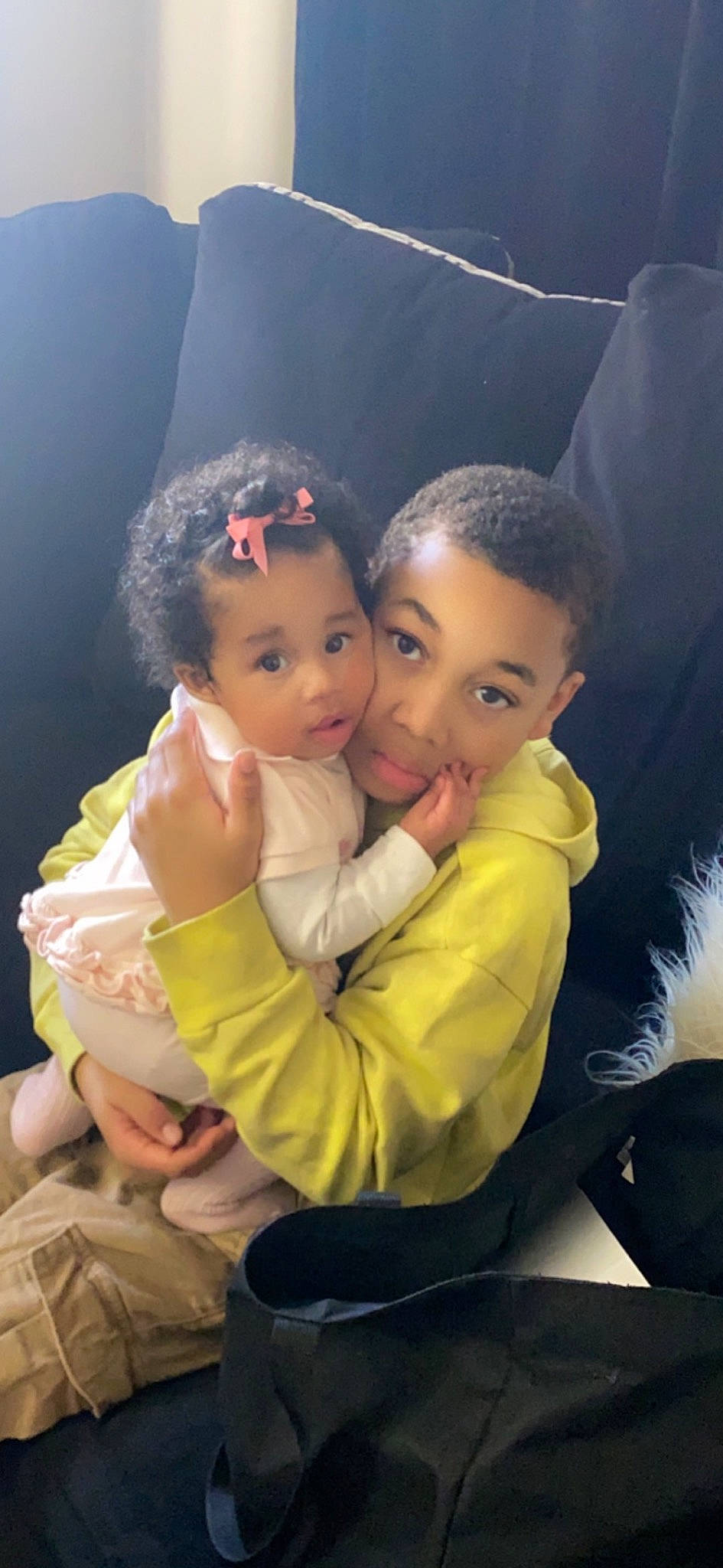 Dakota is registered to the contest to win money with this photo: baby, black_hair, child, event, flash_photography, formal_wear, friendship, fun, gesture, grass, happy, hug, interaction, love, person, portrait_photography, sitting, skin, suit, toddler