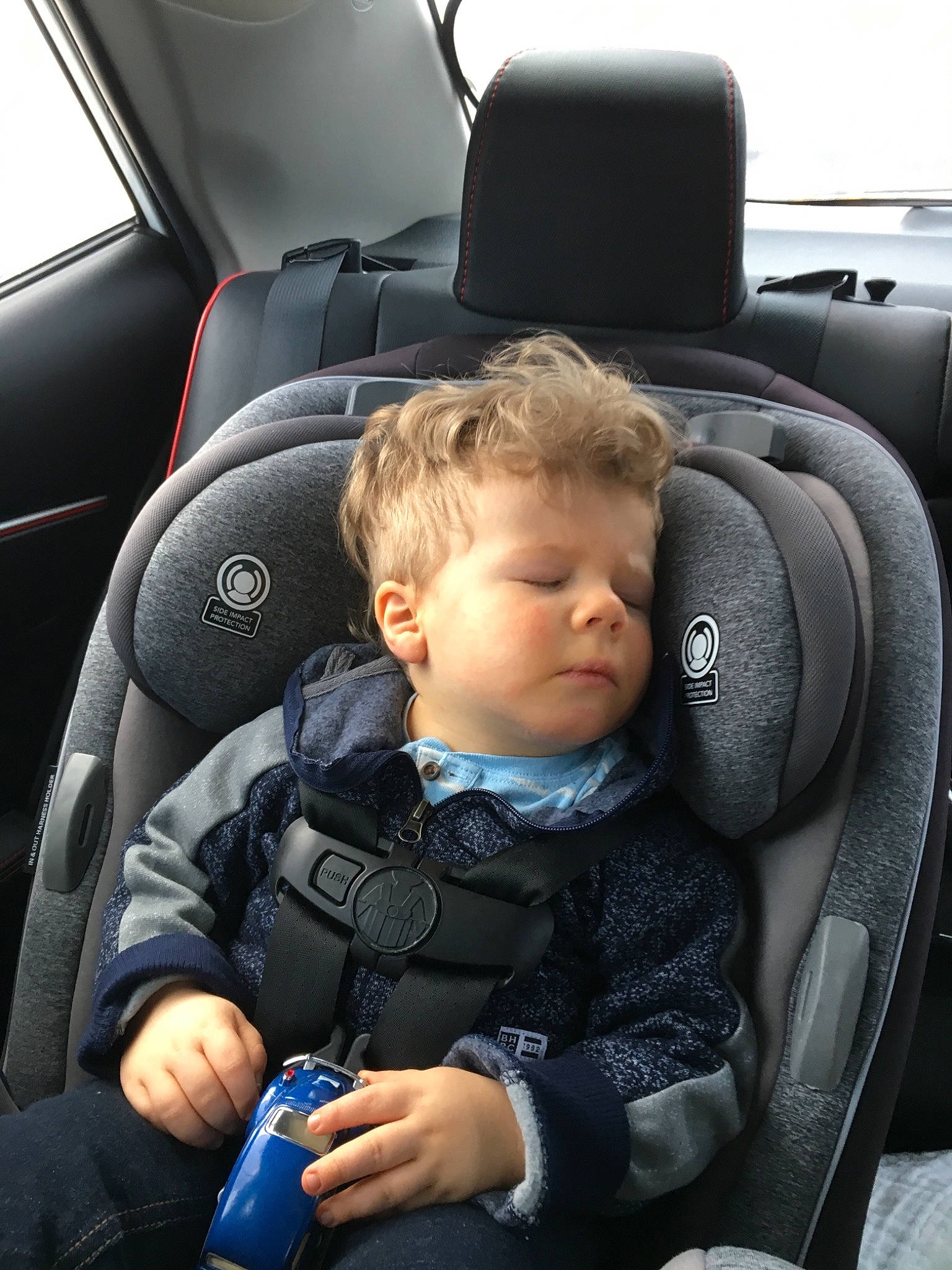 Dominic is registered to the contest to win money with this photo: auto_part, baby, baby_in_car_seat, baby_products, car, car_seat, car_seat_cover, child, comfort, head_restraint, person, product, seat_belt, steering_part, steering_wheel, toddler, vehicle