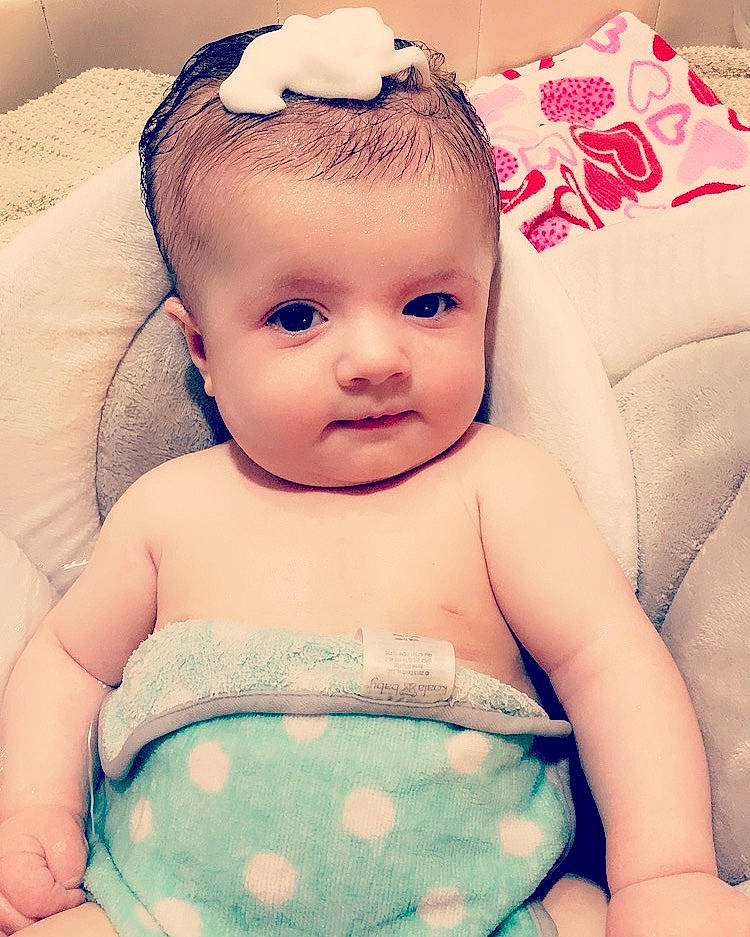 Deacon is registered to the contest to win money with this photo: baby, baby_products, baby_toddler_clothing, beauty, brown_hair, cheek, child, eye, face, forehead, hair_accessory, head, iris, lip, mouth, nose, person, pink, product, skin