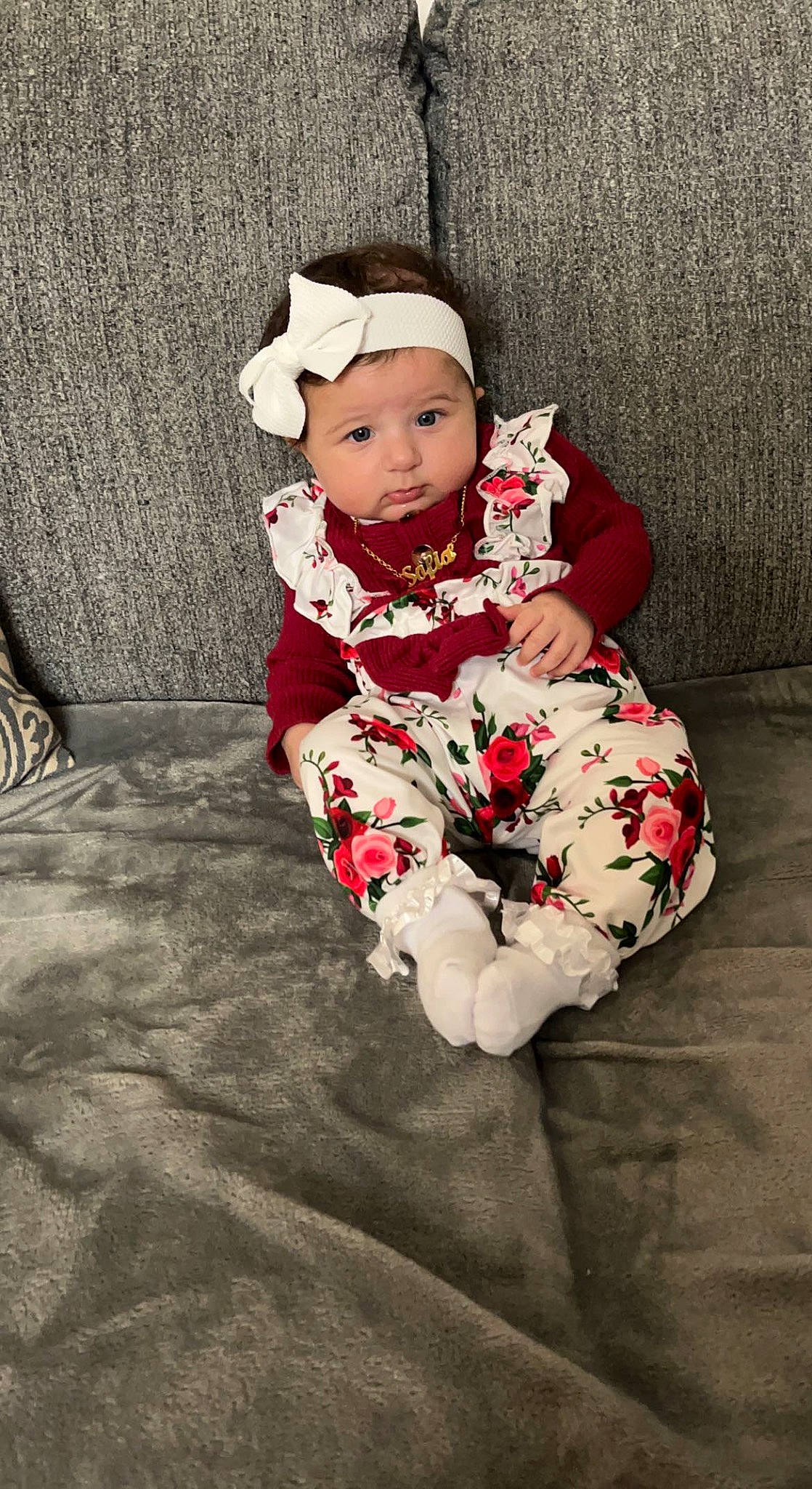 Sofia is registered to the contest to win money with this photo: baby, baby_toddler_clothing, carmine, child, comfort, costume_hat, eye, face, flash_photography, flooring, foot, grass, happy, headwear, human_leg, linens, pattern, person, sitting, sleeve