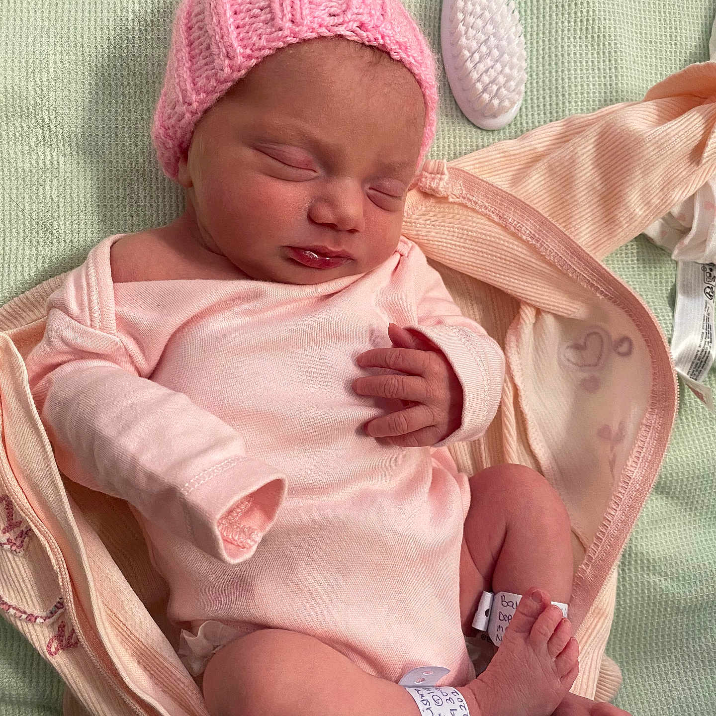 Noella joined the competition — help win amazing prizes! architecture, baby, bed, bodypart, bonnet, building, cap, clothing, face, finger, furniture, glove, hat, head, hospital, newborn, person, photography, portrait, sleeping