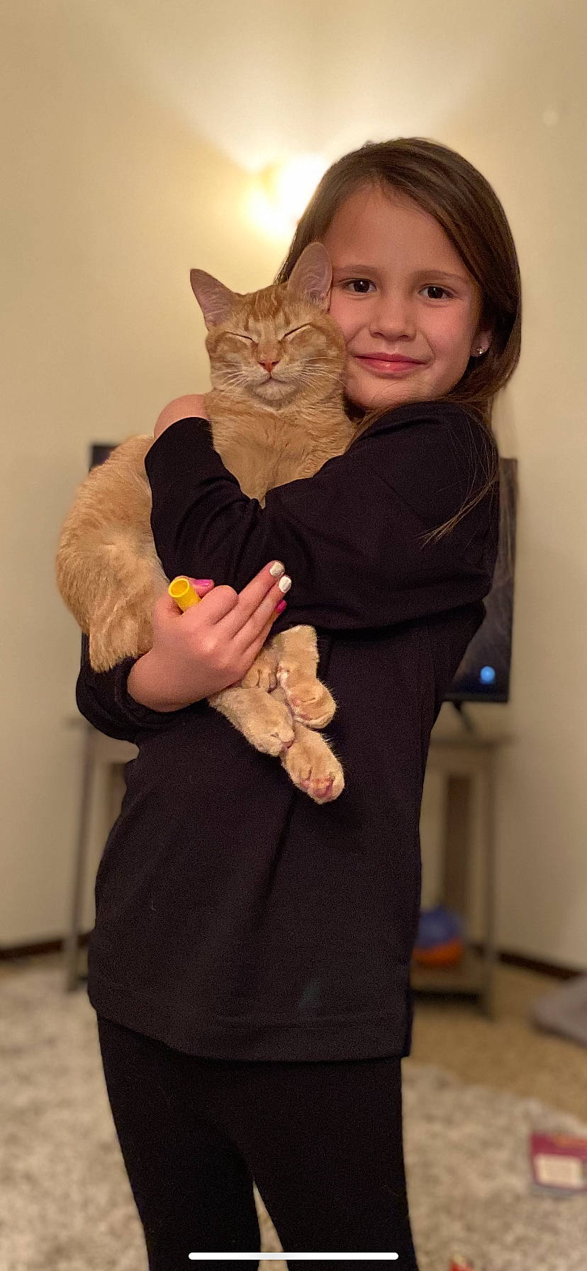 Kenzie is registered to the contest to win money with this photo: arm, carnivore, cat, clothing, ear, event, felidae, fur, gesture, hand, happy, joint, joy, neck, outerwear, person, sleeve, small_to_medium_sized_cats, smile, t_shirt