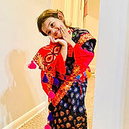 Arwa Musfirah joined the competition — help win amazing prizes! bright_colors, candid, carpet, child, colorful_clothing, cute, expression, hands, happy, indoors, patterned_fabric, person, playful, portrait, pose, shadow, smiling, traditional_outfit, wall, young