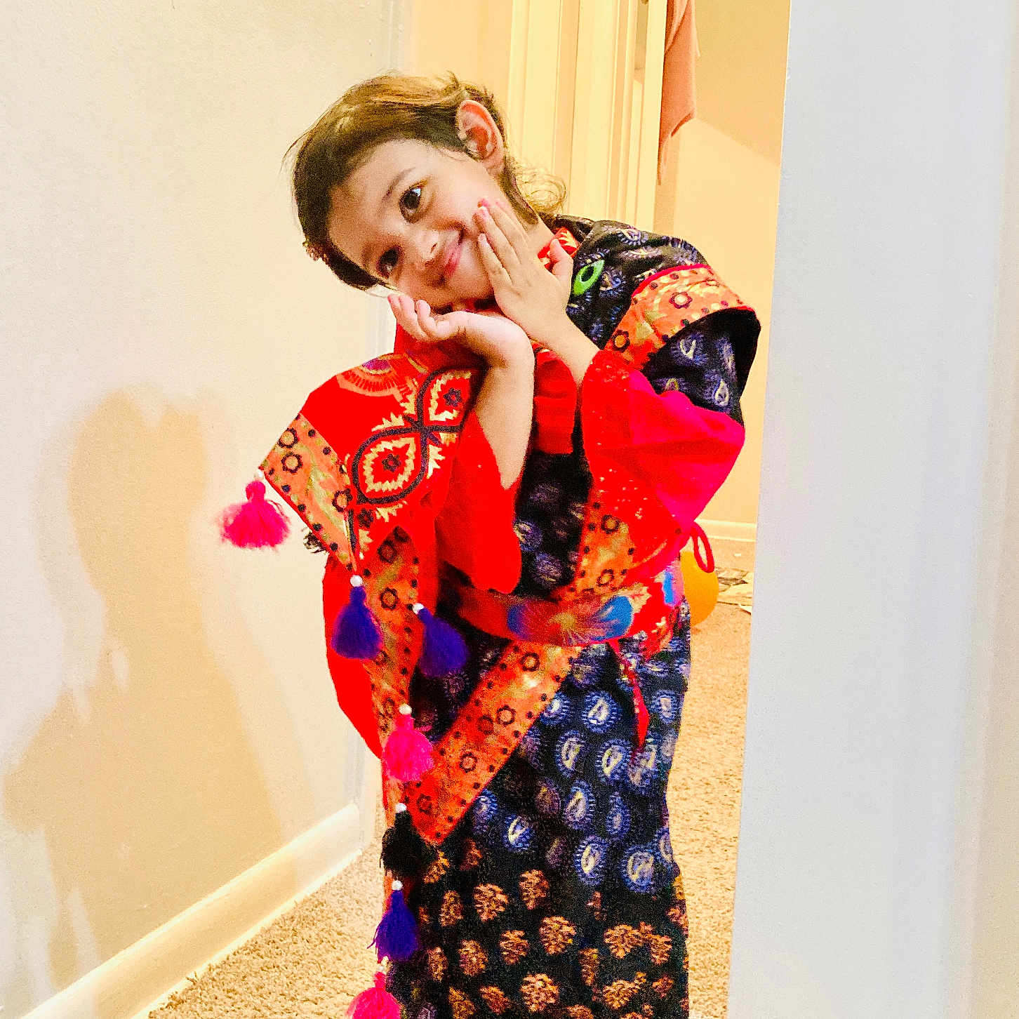 Arwa Musfirah joined the competition — help win amazing prizes! bright_colors, candid, carpet, child, colorful_clothing, cute, expression, hands, happy, indoors, patterned_fabric, person, playful, portrait, pose, shadow, smiling, traditional_outfit, wall, young