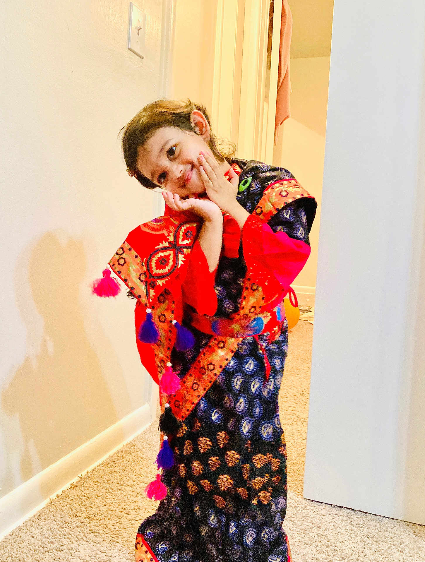 Arwa Musfirah joined the competition — help win amazing prizes! bright_colors, candid, carpet, child, colorful_clothing, cute, expression, hands, happy, indoors, patterned_fabric, person, playful, portrait, pose, shadow, smiling, traditional_outfit, wall, young