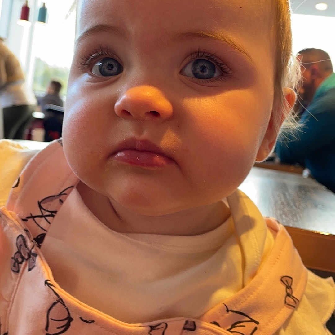 Mali-Jo joined the competition — help win amazing prizes! adult, baby, bib, blonde, bodypart, cafe, cafeteria, clothing, couch, cutlery, ear, face, female, finger, food, foodcourt, frown, furniture, hair, hand
