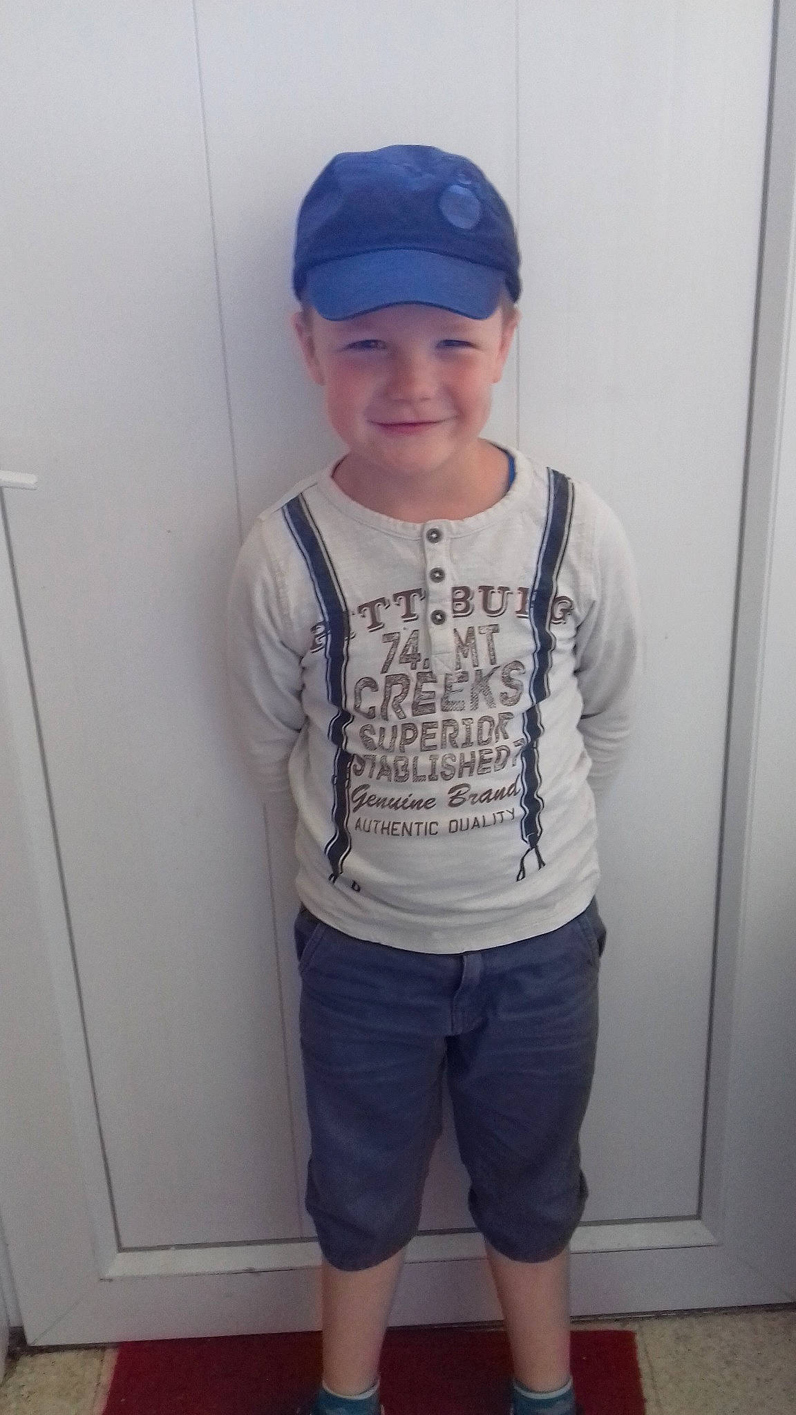 Dayvon a rejoint le concours — aidez-le/la à gagner de superbes lots ! blue, cap, child, clothing, cool, headgear, joy, outerwear, person, shorts, shoulder, sleeve, standing, t_shirt, toddler, top