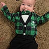 baby, infant, carpet, green_clothing, bow_tie, black_pants, smiling, happy, lying_down, cute, child, toddler, indoor, floor, plaid, clothing, person, hair_tie, celebration, cheerful
