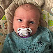 Lou participe au concours pour gagner de l'argent avec cette photo : baby, pacifier, blue_outfit, bear_ears, plush_seat, curious_eyes, infant, cute, cozy, child, face, head, patterned_fabric, animal_embroidery, indoors, resting, young_child, soft_texture, closeup, portrait