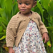 Kamryn is registered to the contest to win money with this photo: child, toddler, girl, portrait, outdoor, garden, plants, flowers, floral_dress, cardigan, pink_bow, braids, smiling, standing, shoes, grass, fashion, natural_light, full_body, safe