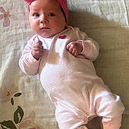 Alivia Isaac joined the competition — help win amazing prizes! baby, infant, pink_bow, headband, onesie, heart, blanket, floral_pattern, socks, lying_down, cute, portrait, child, small_hands, indoors, soft_lighting, newborn, face, young_child, cozy
