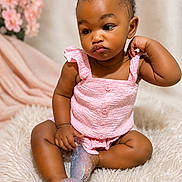 Xya is registered to the contest to win money with this photo: baby, infant, child, pink_clothing, sitting, fluffy_rug, portrait, curious_expression, indoor, soft_lighting, decor, flowers, skin, legs, hands, head, hair, cute, adorable, fashion