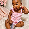baby, infant, child, pink_clothing, sitting, fluffy_rug, portrait, curious_expression, indoor, soft_lighting, decor, flowers, skin, legs, hands, head, hair, cute, adorable, fashion
