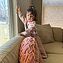 Reign is registered to the contest to win money with this photo: blanket, child, clothing, couch, cushion, face, female, furniture, girl, happy, head, homedecor, indoors, interiordesign, person, photography, portrait, sitting, sleeve, window