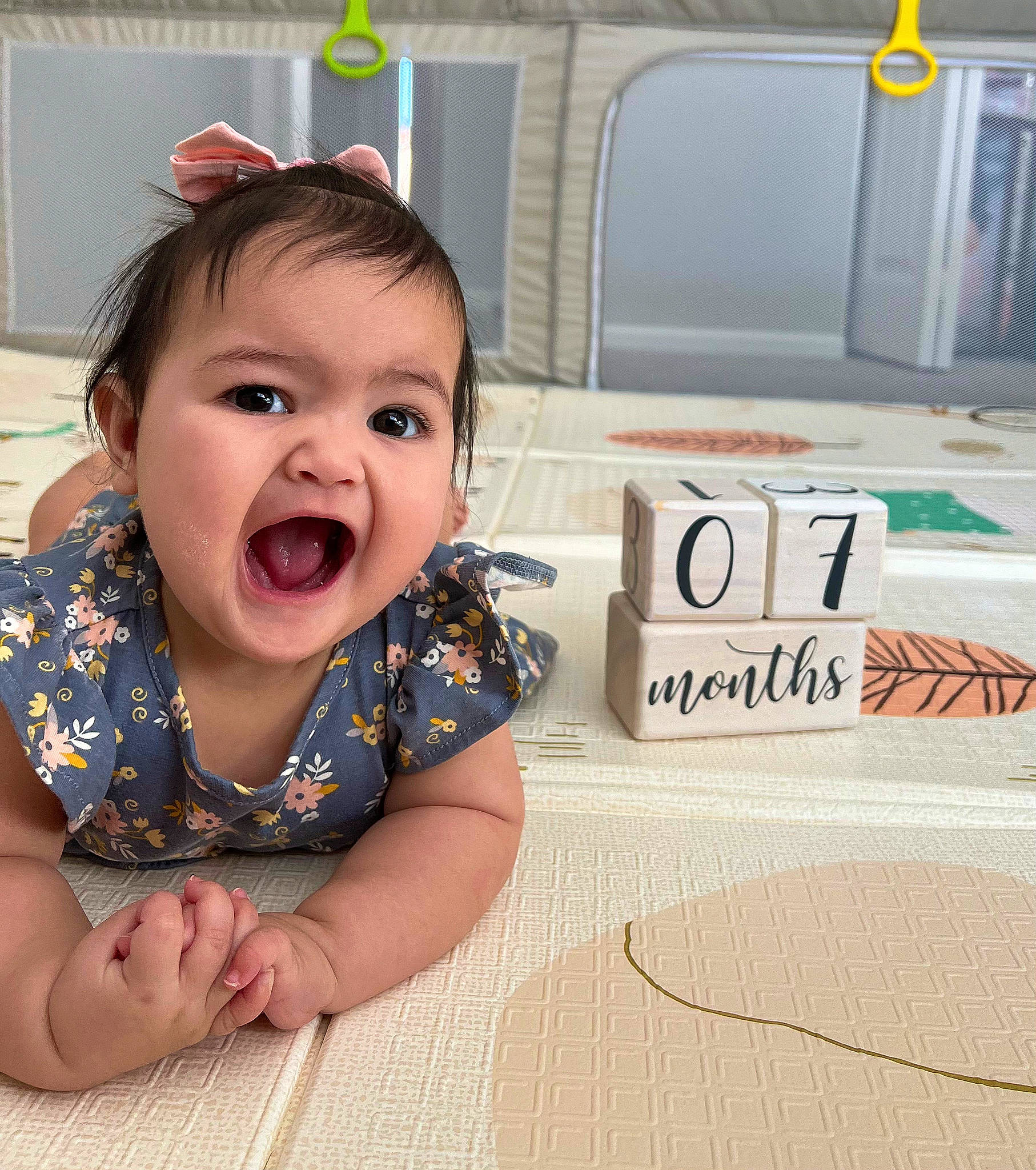 Mariella is registered to the contest to win money with this photo: baby, baby_toddler_clothing, cheek, child, comfort, eye, eyelash, flooring, fun, happy, hardwood, iris, nose, pattern, person, sitting, skin, sleeve, smile, toddler