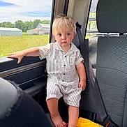 Maverick joined the competition — help win amazing prizes! toddler, child, car_interior, seat, window, striped_clothing, barefoot, blonde_hair, blue_eyes, yellow_towel, orange_ring, daylight, green_fields, car_seatbelt, portrait, sitting, young_child, casual_clothing, curious_expression, backseat