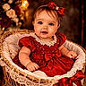 baby, child, girl, red_dress, bow, lace, wicker_basket, portrait, smiling, blue_eyes, bracelet, headband, indoor, decorative, soft_lighting, cute, infant, fashion, holiday, celebration