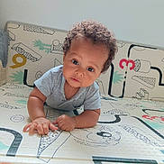 Mahé participe au concours pour gagner de l'argent avec cette photo : baby, child, curly_hair, patterned_mat, indoor, cute, infant, looking_at_camera, playful, numbers, colorful, soft_lighting, toddler, clothing, short_sleeves, hands, face, expression, young_child, floor_mat