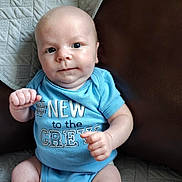 Salem joined the competition — help win amazing prizes! arms, baby, blanket, blue_clothing, child, cute, expression, face, furniture, indoor, infant, leather_couch, legs, newborn, onesie, portrait, quilt, sitting, skin, smile