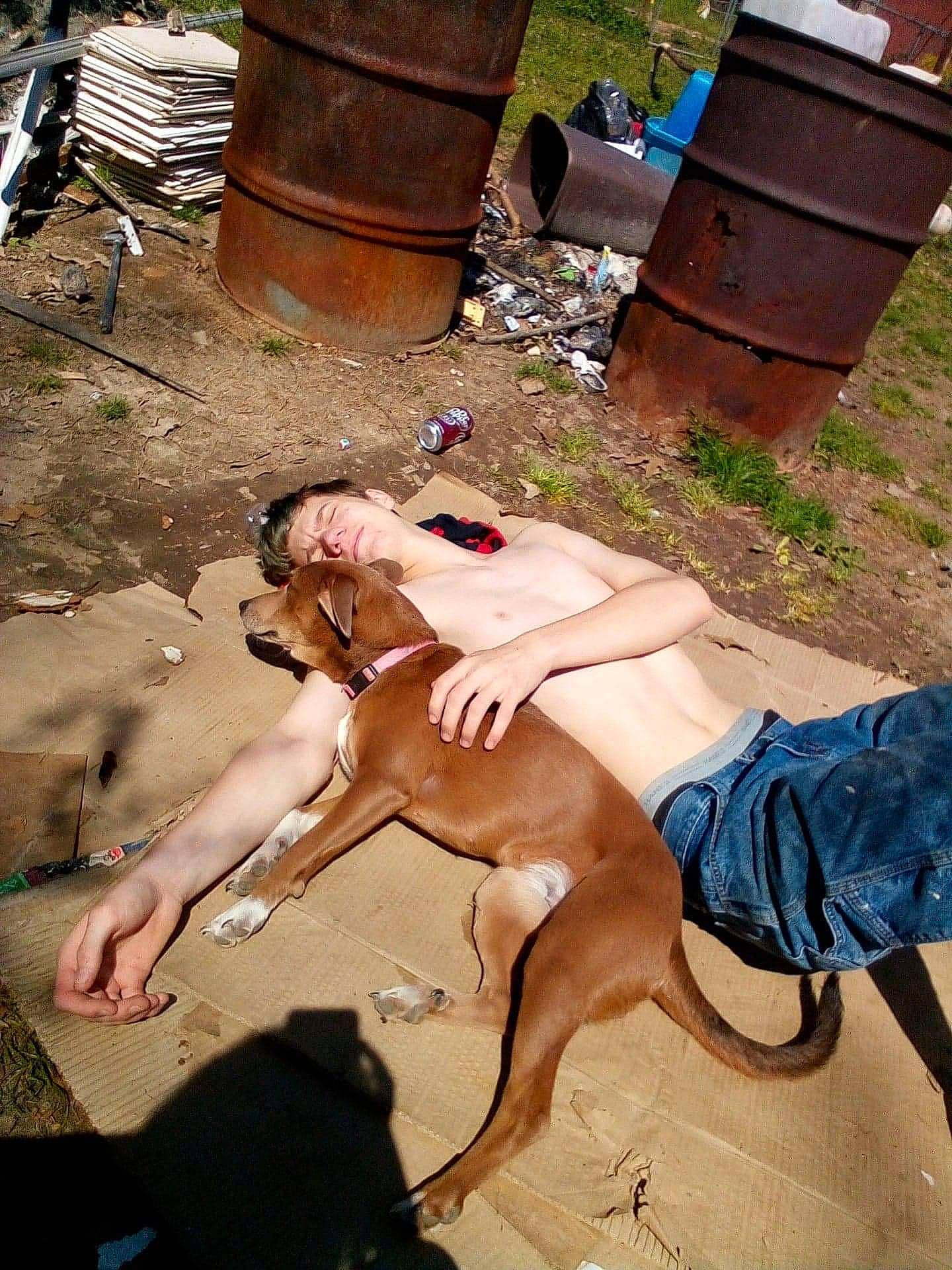 Daisy is registered to the contest to win money with this photo: abdomen, barechested, chest, fawn, foot, fun, grass, human_leg, knee, landscape, leisure, muscle, recreation, sitting, soil, sunglasses, tail, thigh, trunk, wood