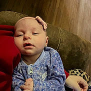 Everly joined the competition — help win amazing prizes! baby, bow, casual, clothing, comfort, couch, fabric, hand, headband, indoor, infant, leopard_print, nike, onesie, pacifier, person, purple, resting, sleepy, wood_floor