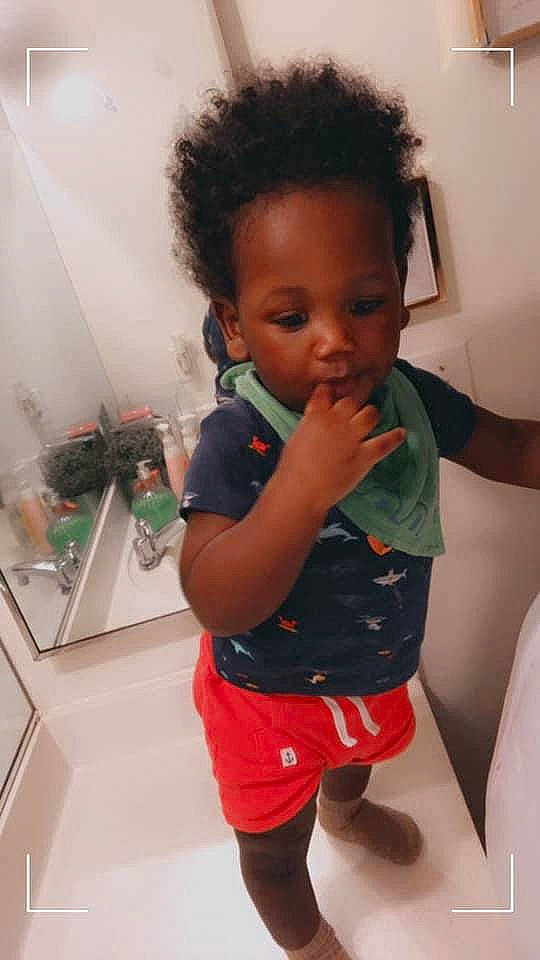 Kristopher is registered to the contest to win money with this photo: baby, baby_toddler_clothing, cheek, chin, eyelash, finger, hair, iris, joint, mouth, nose, person, shorts, shoulder, skin, sleeve, standing, thigh, thumb, toddler