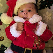 Alexander joined the competition — help win amazing prizes! baby, child, santa_hat, santa_costume, holiday, christmas, festive, red_clothing, fur_trim, infant, blanket, pattern, smiling, cute, portrait, indoors, holiday_season, young_child, festive_outfit, christmas_decor