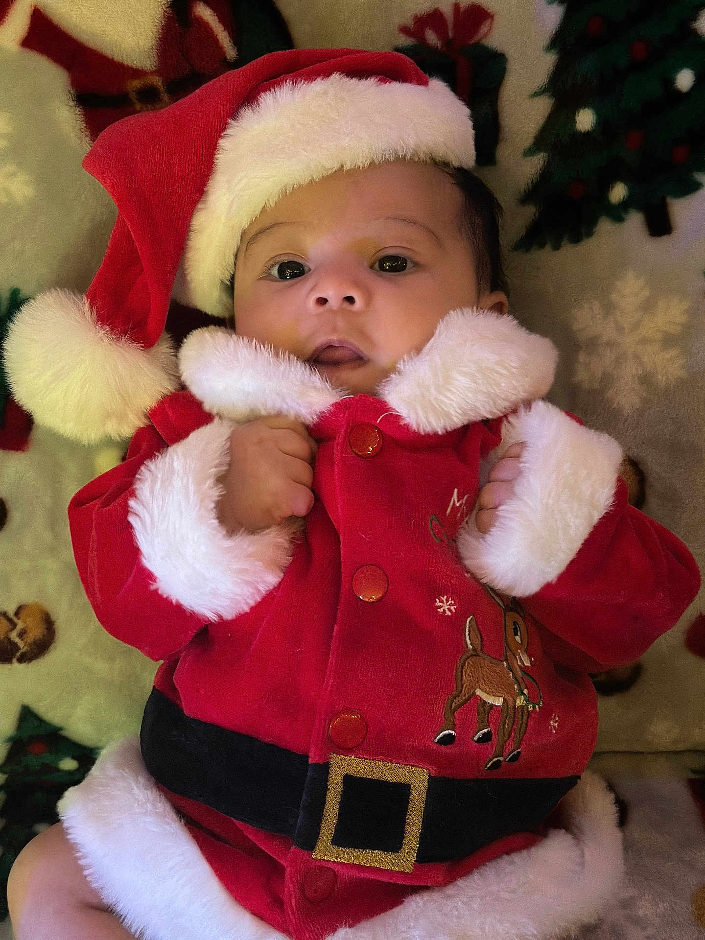 Alexander joined the competition — help win amazing prizes! baby, child, santa_hat, santa_costume, holiday, christmas, festive, red_clothing, fur_trim, infant, blanket, pattern, smiling, cute, portrait, indoors, holiday_season, young_child, festive_outfit, christmas_decor