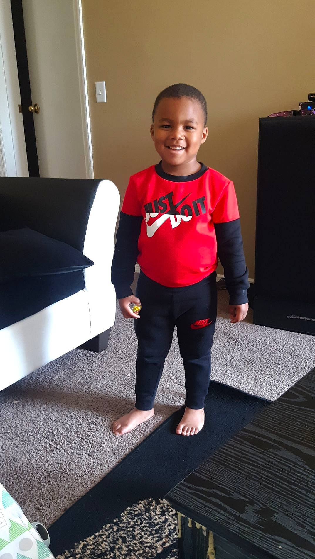 Rashawn joined the competition — help win amazing prizes! baby_toddler_clothing, carpet, event, floor, flooring, formal_wear, human_leg, joy, knee, neck, person, room, shoulder, sitting, sleeve, smile, sportswear, standing, sweatpant, t_shirt