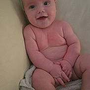 Gaberiel Samuel is registered to the contest to win money with this photo: baby, infant, smiling, naked, couch, towel, skin, child, happy, sitting, cute, face, arms, legs, indoors, young, portrait, chubby, expression, people