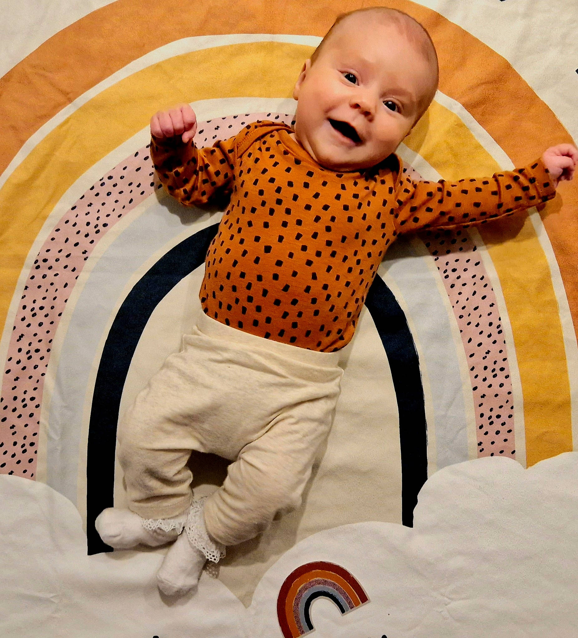 Ayda is registered to the contest to win money with this photo: baby, baby_products, baby_toddler_clothing, child, comfort, flooring, fun, gesture, happy, human_body, linens, orange, pattern, person, room, sleeve, smile, t_shirt, textile, toddler