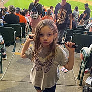 Niomi joined the competition — help win amazing prizes! child, girl, baseball, bat, stadium, crowd, sports, outdoor, casual_clothing, shorts, tshirt, pink_shoes, concrete, seating, people, game, daylight, fun, playful, spectators