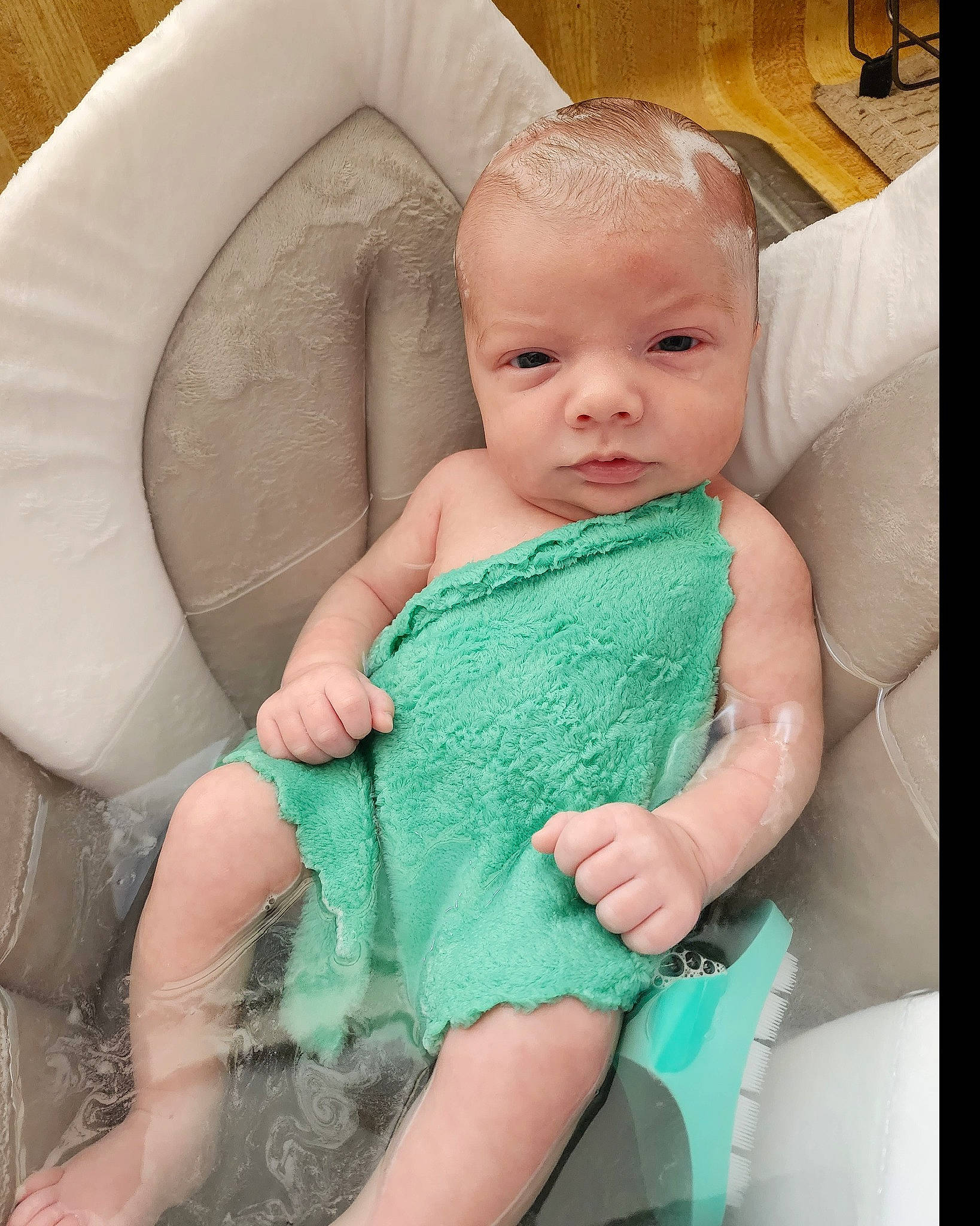 Evan is registered to the contest to win money with this photo: aqua, azure, baby, baby_toddler_clothing, cheek, comfort, dress, eye, face, finger, gesture, happy, head, iris, person, sitting, skin, sleeve, textile, thumb