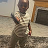 Siya joined the competition — help win amazing prizes! toddler, child, standing, pointing, indoors, living_room, fireplace, television, carpet, rug, striped_shirt, pants, sock, barefoot, pink, portrait, home, family_photos, cartoon, playful